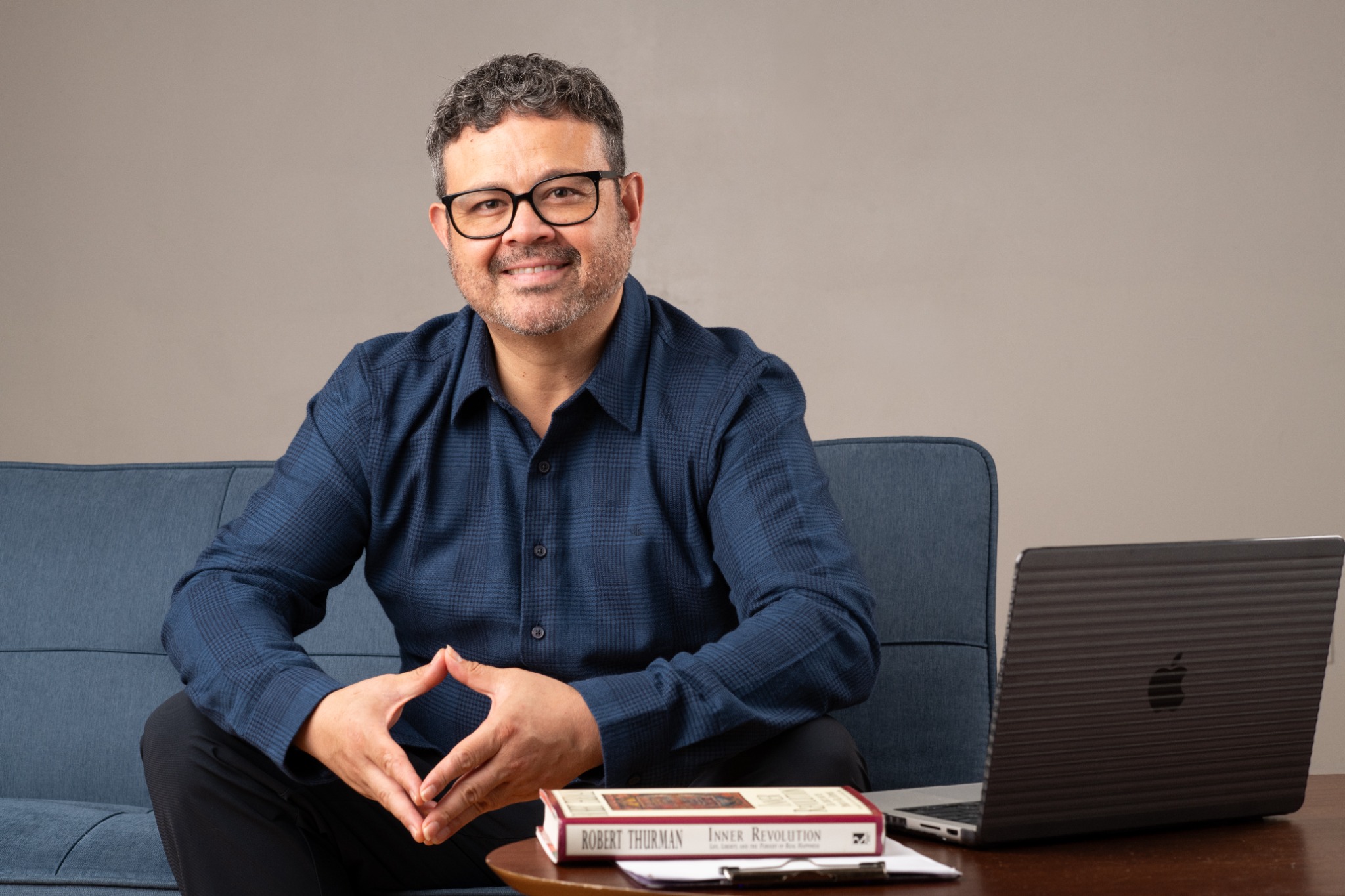 Luis Medina seated in his therapy space